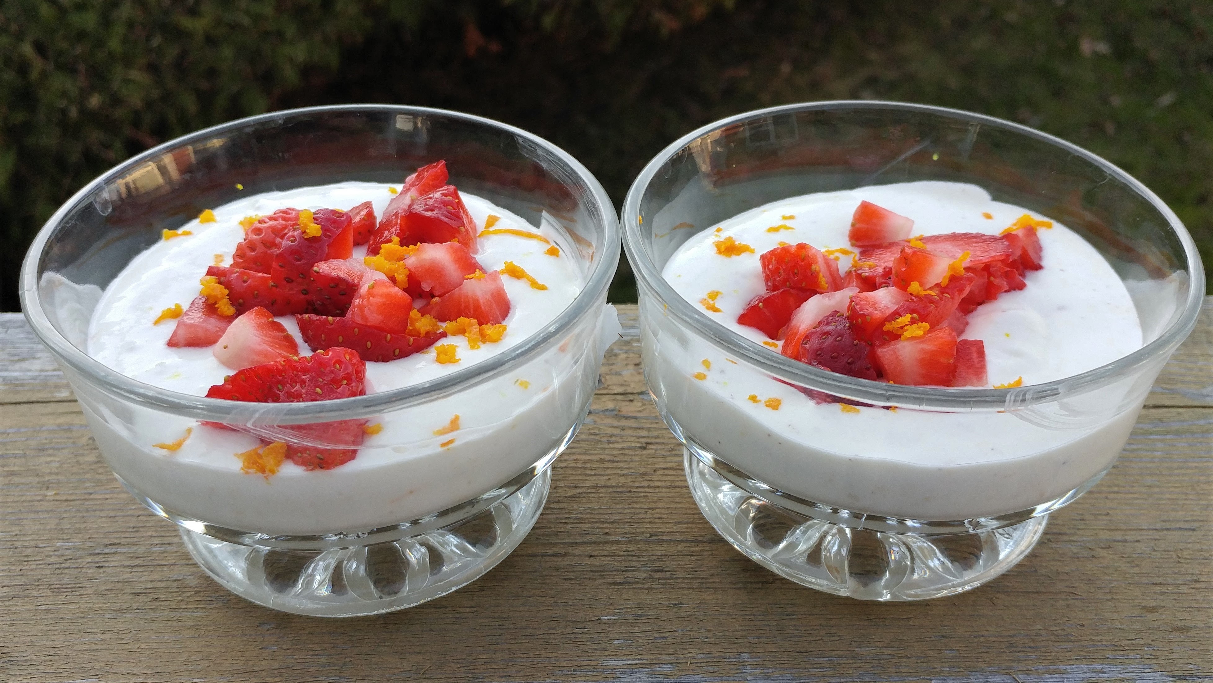 Cultured dessert with fresh strawberries and orange zest